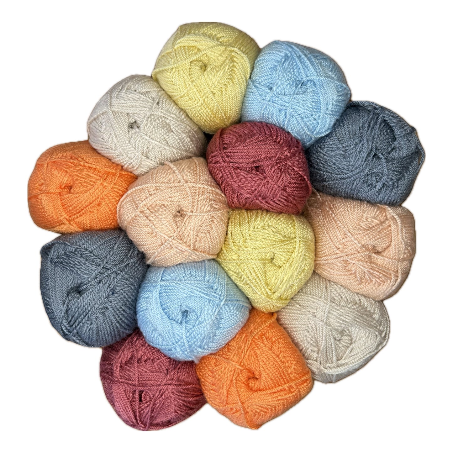Patchwork with Busyfingers Frosty Fruit yarn set in raspberry, pumpkin, sherbet, duck egg blue, steel, and natural cream acrylic.