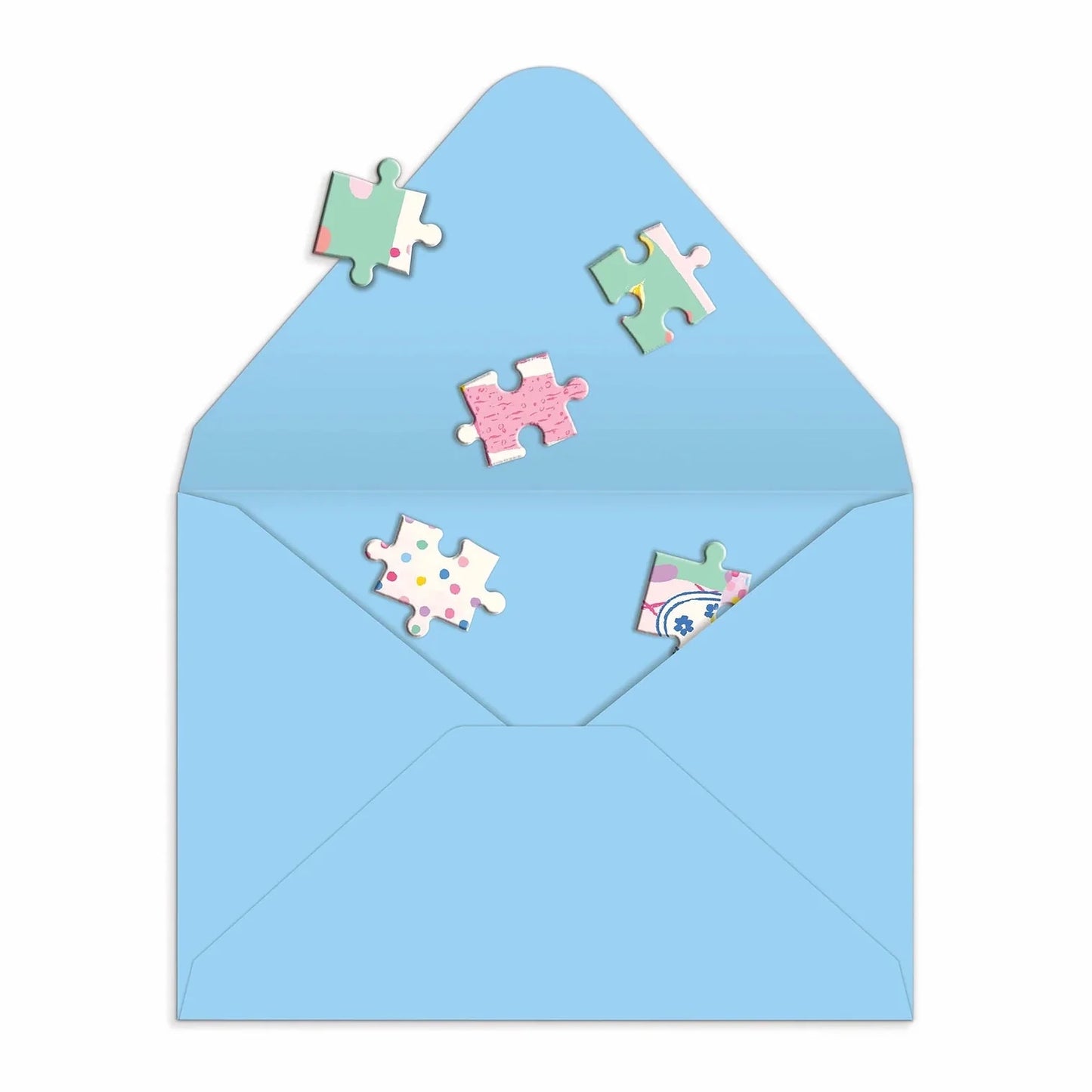 Patchwork with Busyfingers Confetti Birthday Cake greeting card puzzle pieces scattered from a light blue envelope. Features pastel patterns and confetti dots.