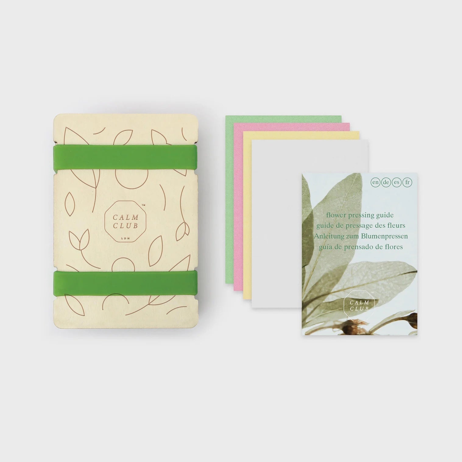 Patchwork with Busyfingers Luckies Calm Club flower press kit with green elastic bands, botanical print, and instruction booklet.