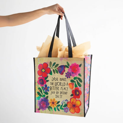 Patchwork with Busyfingers Happy Bag XL, a reusable grocery bag made from recycled water bottles, featuring a floral design and the quote "You make the world a better place just by being in it."