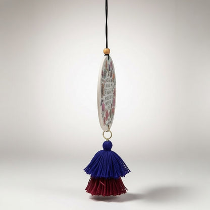 Patchwork with Busyfingers oval air freshener with floral print and quote, featuring blue and burgundy tassels.