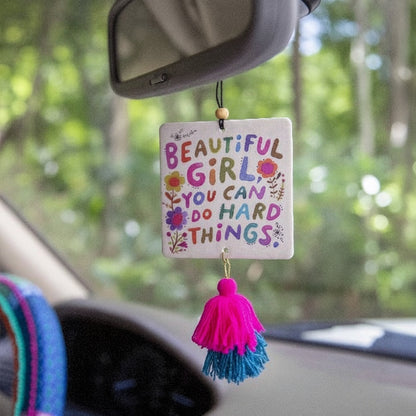 Patchwork with Busyfingers air freshener with colorful text 'Beautiful Girl, You Can Do Hard Things' and pink and blue tassels.