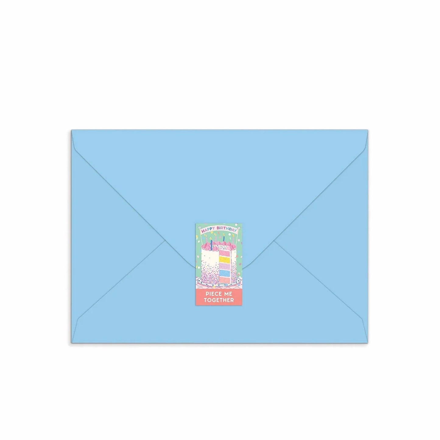 Patchwork with Busyfingers Confetti Birthday Cake greeting card puzzle on a light blue envelope, featuring a slice of cake with colourful layers and sprinkles.