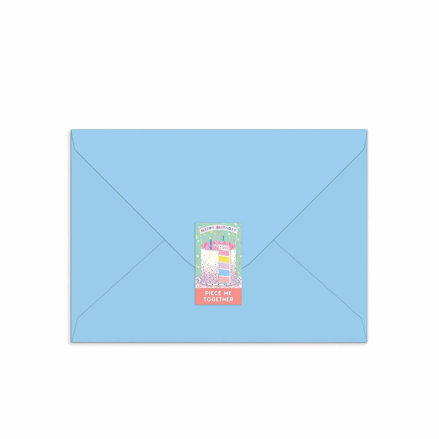Patchwork with Busyfingers Confetti Birthday Cake greeting card puzzle on a light blue envelope, featuring a slice of cake with colourful layers and sprinkles.