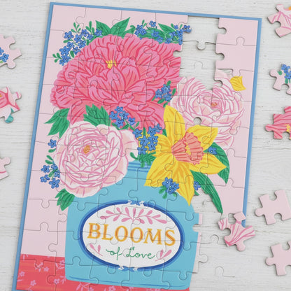 Patchwork with Busyfingers Blooms of Love greeting card puzzle featuring a bouquet of pink and yellow flowers in a blue vase on a pink background.