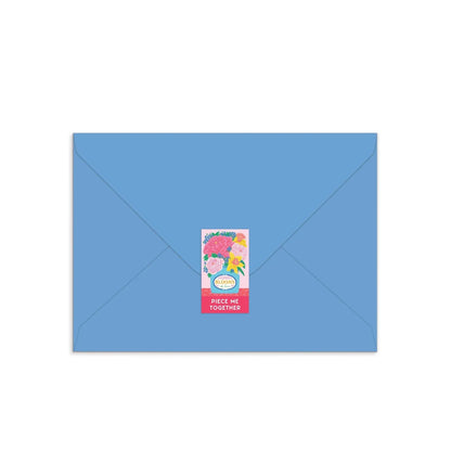 Patchwork with Busyfingers Blooms of Love greeting card puzzle on a blue envelope, featuring a sticker with a floral arrangement and the text "PIECE ME TOGETHER".