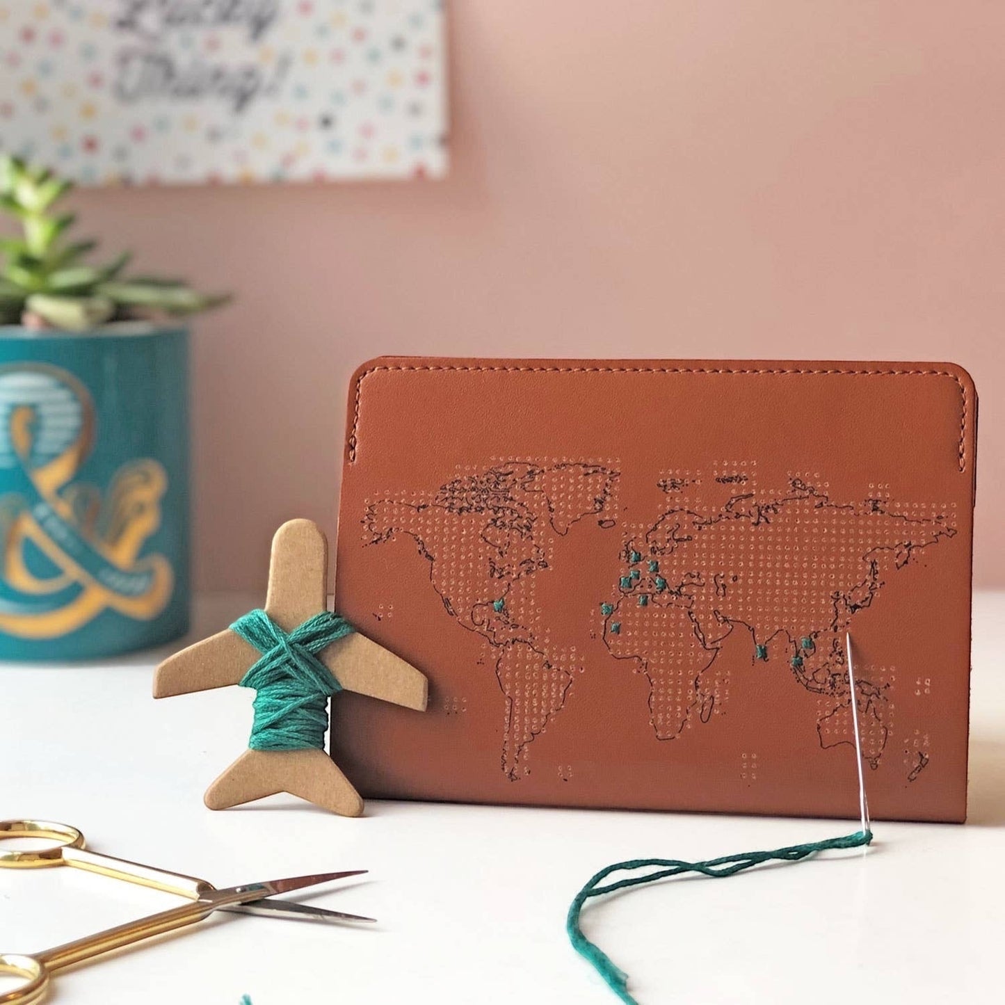 Patchwork with Busyfingers brown leather passport cover with world map design, includes emerald thread and needle for stitching visited countries.