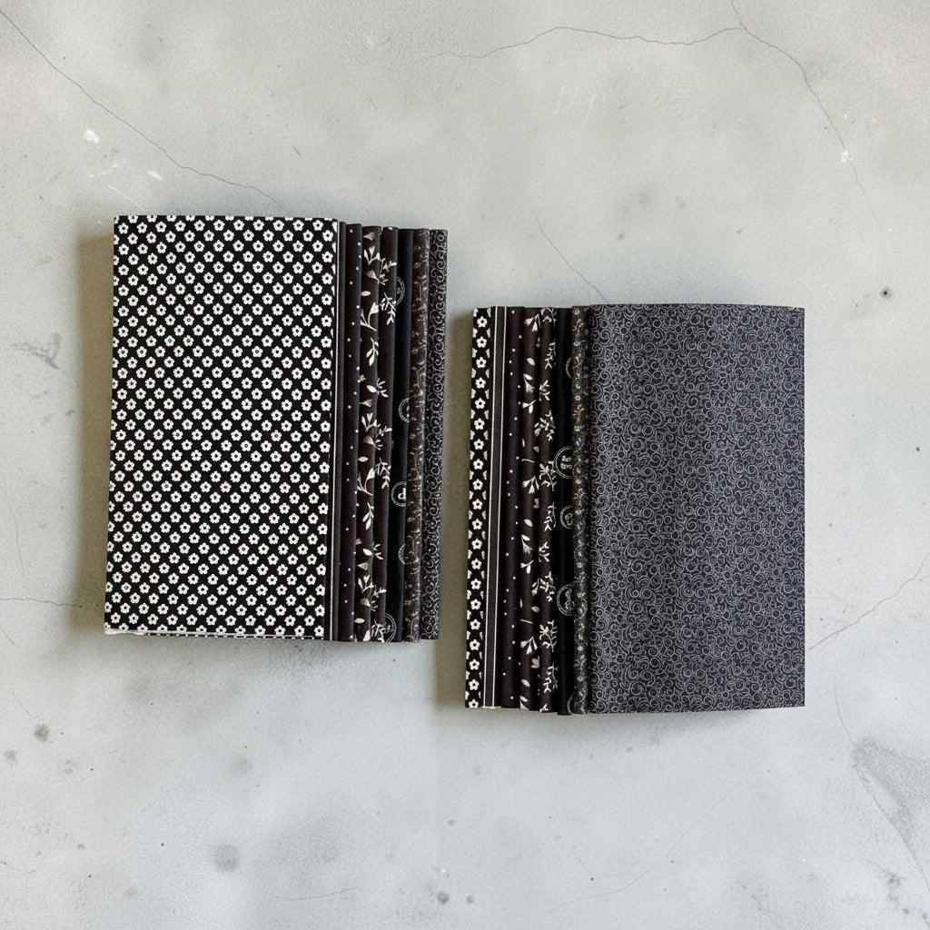 Patchwork with Busyfingers Classic Tuxedo 8-piece cotton fat eighth fabric pack with black and white floral prints.