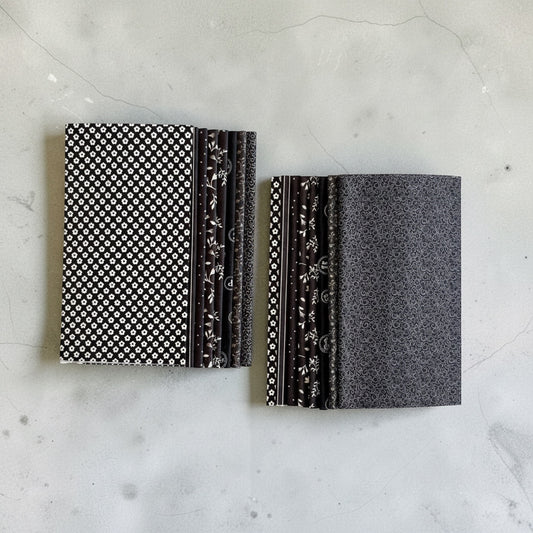 Patchwork with Busyfingers Classic Tuxedo 8-piece cotton fat eighth fabric pack with black and white floral prints.