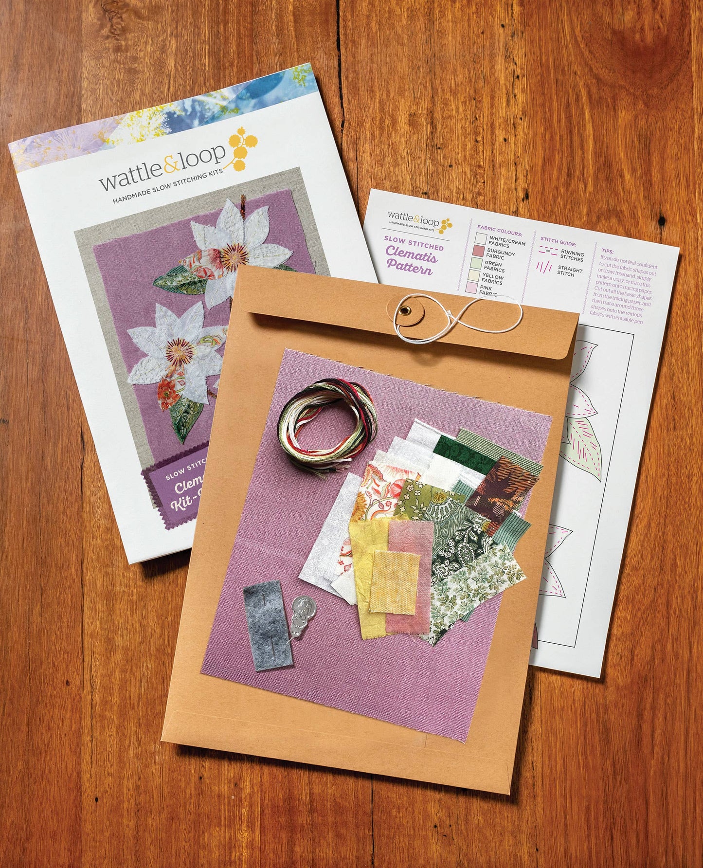Patchwork with Busyfingers Clematis Purple slow stitching kit with fabric scraps, embroidery thread, and pattern guide.