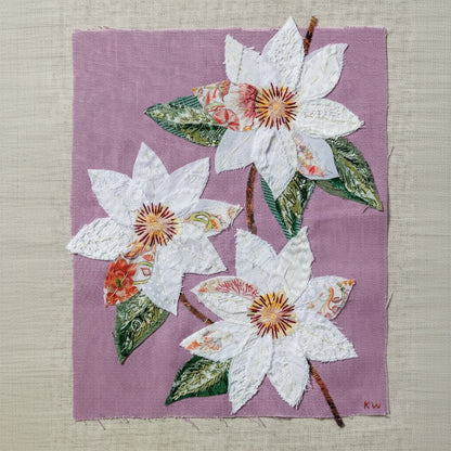 Patchwork with Busyfingers Clematis slow stitching kit featuring white floral applique on a pastel purple linen base.