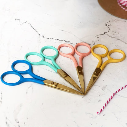Patchwork with Busyfingers coral embroidery scissors with gold blades and coloured handles in blue, teal, coral, and yellow.