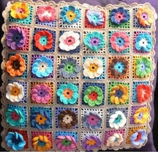 Patchwork with Busyfingers crochet cushion featuring colourful 3D flower motifs on square backgrounds