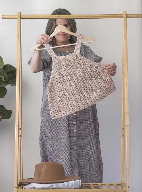 Patchwork with Busyfingers Crochet Layers to Love book featuring a woman holding a beige crochet tank top pattern.