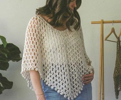 Woman wearing a cream-colored crochet poncho from the Patchwork with Busyfingers Crochet Layers to Love book.
