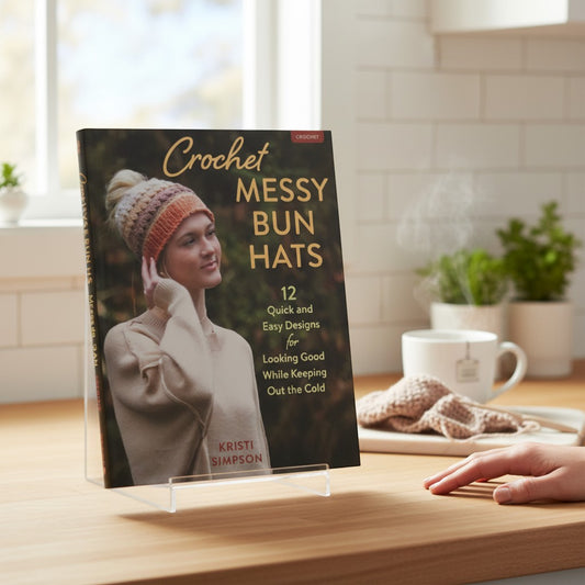 Patchwork with Busyfingers Crochet Messy Bun Hats book cover featuring a woman wearing a colorful, textured crochet hat with her hair in a bun.