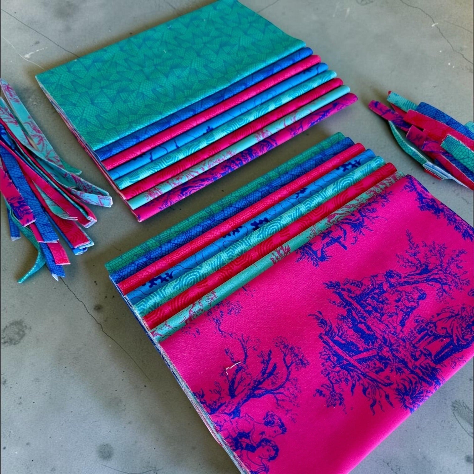 Patchwork with Busyfingers Electric Lagoon 8-piece fat eighth cotton fabric pack with vibrant blue and pink prints.