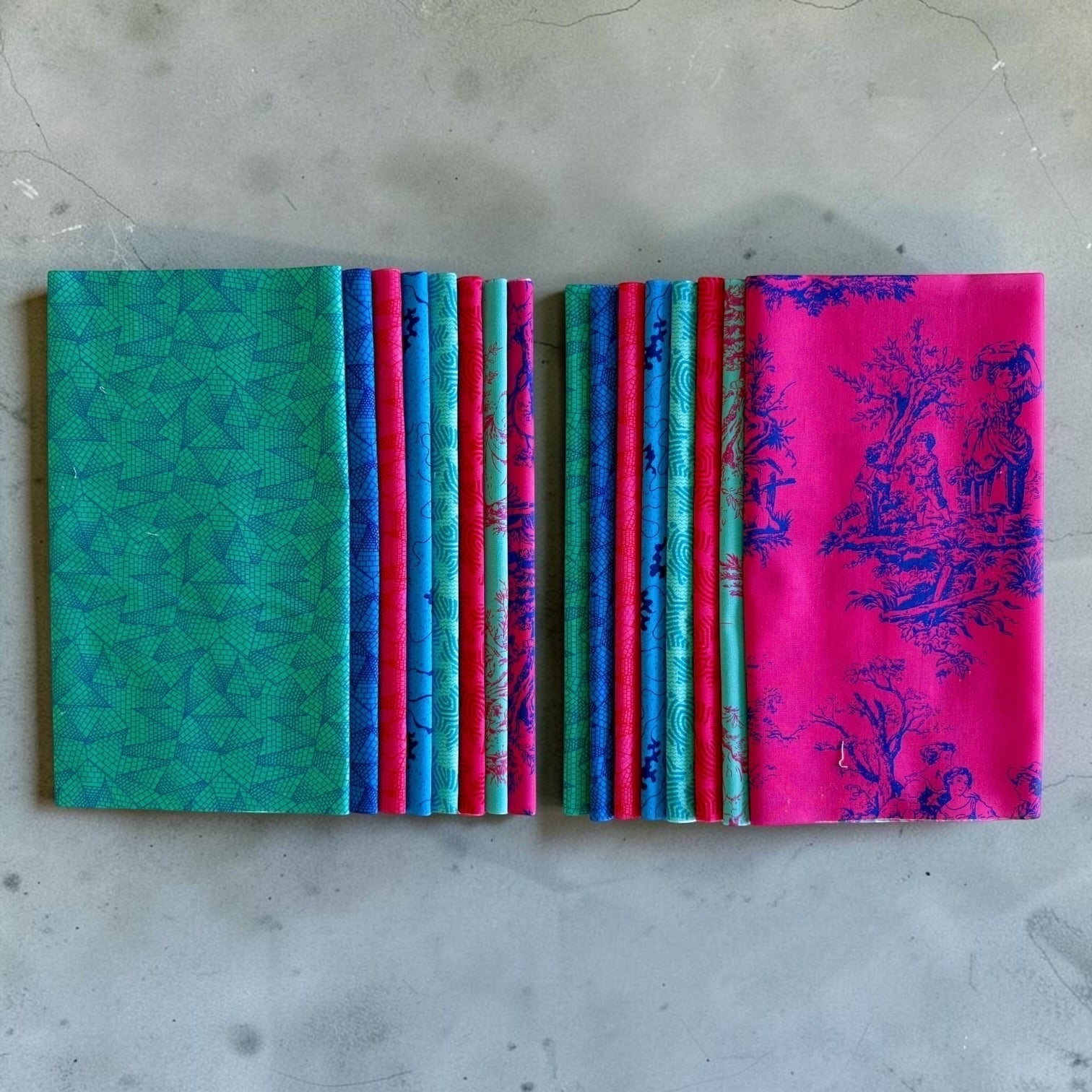 Patchwork with Busyfingers Electric Lagoon fat eighth cotton fabric pack with 8 assorted blue, teal, and pink prints.