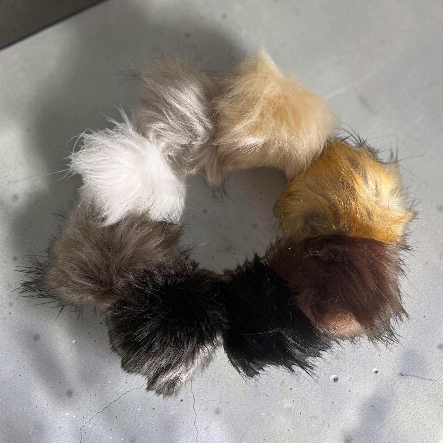 Patchwork with Busyfingers plush faux fur pom poms in a variety of neutral and brown tones for beanie hats