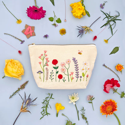 Patchwork with Busyfingers floral embroidery kit on a canvas zip pouch with a bee and meadow flowers design.