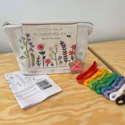 Patchwork with Busyfingers floral embroidery kit for a zip pouch with colourful flowers and a bee design. Includes threads, needle, and instructions.