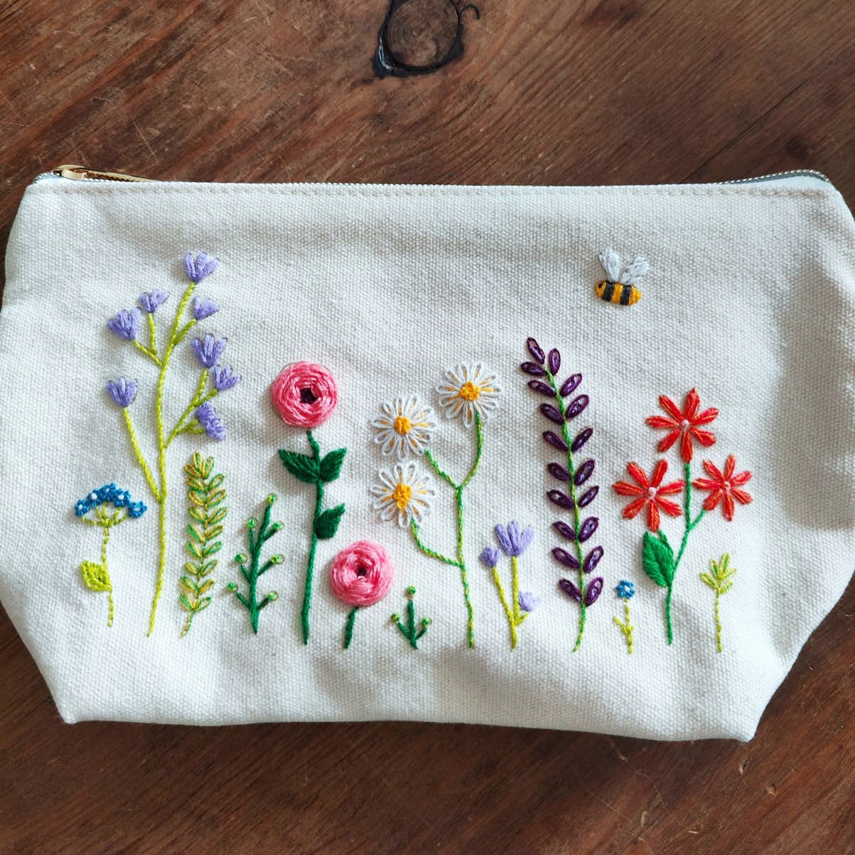 Patchwork with Busyfingers canvas zip pouch with floral embroidery kit featuring flowers and a bee.