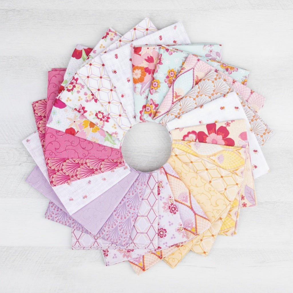 Patchwork with Busyfingers Flourish fabric bundle featuring 21 assorted floral and geometric cotton prints in pink and yellow