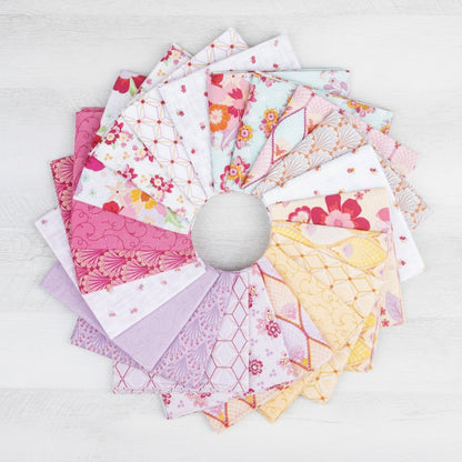 Patchwork with Busyfingers Flourish fabric bundle featuring 21 assorted floral and geometric cotton prints in pink and yellow