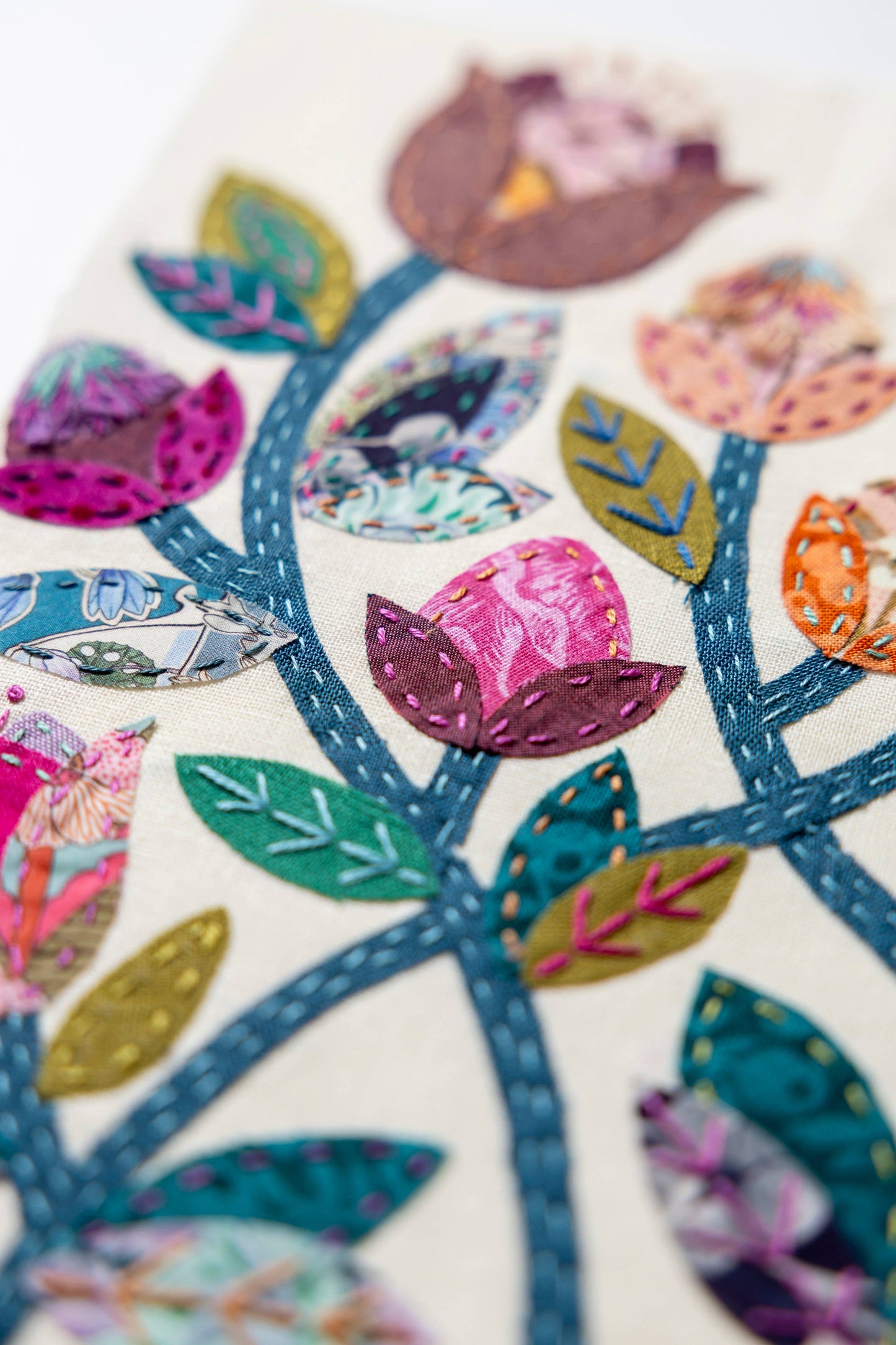 Patchwork with Busyfingers Folk Fleur slow stitching kit featuring vibrant floral fabric applique on linen background