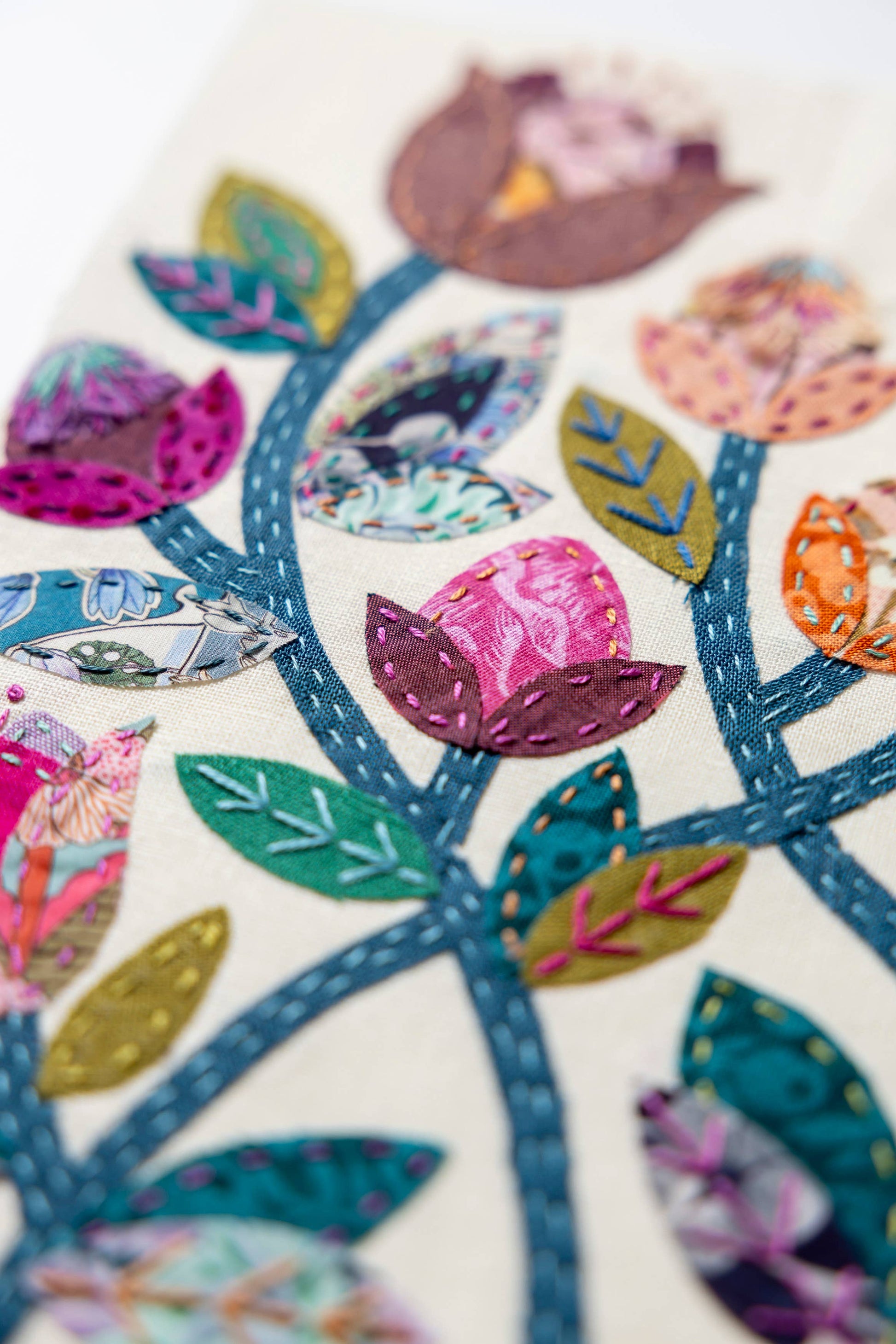 Patchwork with Busyfingers Folk Fleur slow stitching kit featuring vibrant floral fabric applique on linen background