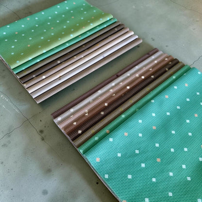 Patchwork with Busyfingers Forest Fog 8-piece cotton fabric fat eighth pack in green and brown geometric prints.