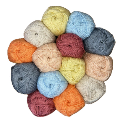 Patchwork with Busyfingers Frosty Fruit yarn set in raspberry, pumpkin, sherbet, duck egg blue, steel, and natural cream acrylic.