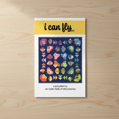 Patchwork with Busyfingers I Can Fly quilt pattern booklet featuring colorful improv-style moth motifs on navy blue.