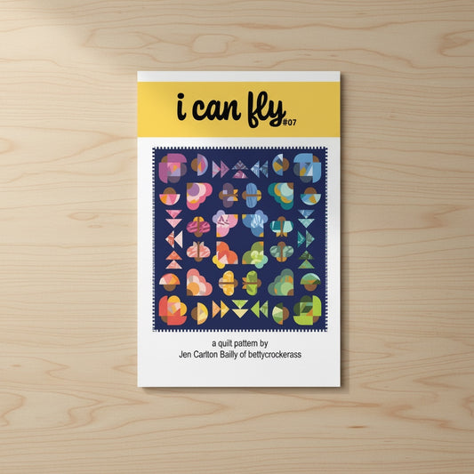 Patchwork with Busyfingers I Can Fly quilt pattern booklet featuring colorful improv-style moth motifs on navy blue.