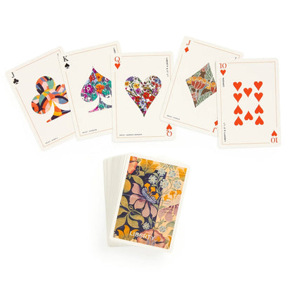 Patchwork with Busyfingers Liberty Archive playing cards featuring floral and abstract designs on card faces and a collage of floral prints on the deck.