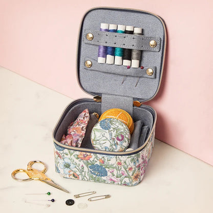 Patchwork with Busyfingers Liberty small sewing cube with floral print, grey interior, thread spools, needles, scissors, and pins.