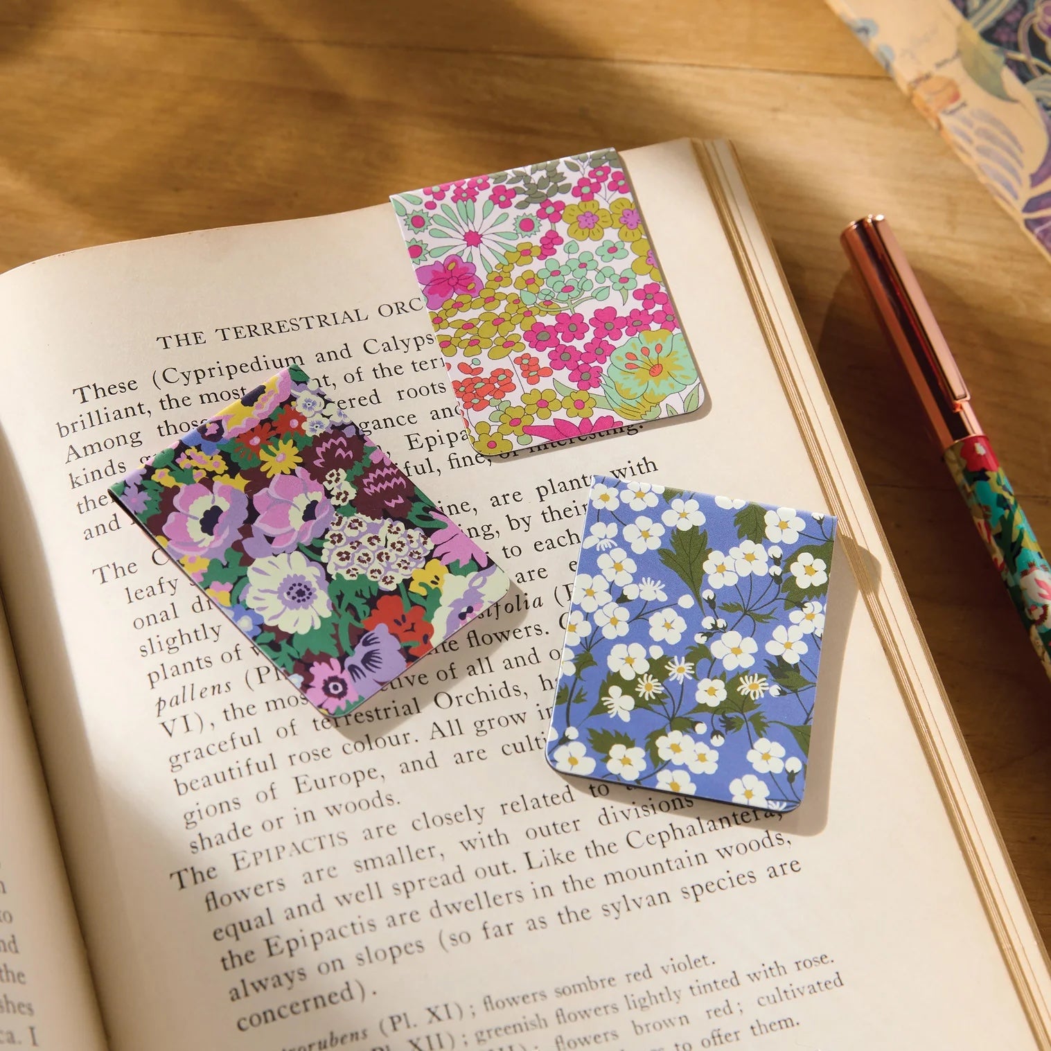 Patchwork with Busyfingers Liberty magnetic bookmarks featuring floral prints on a book page. Set of 3.