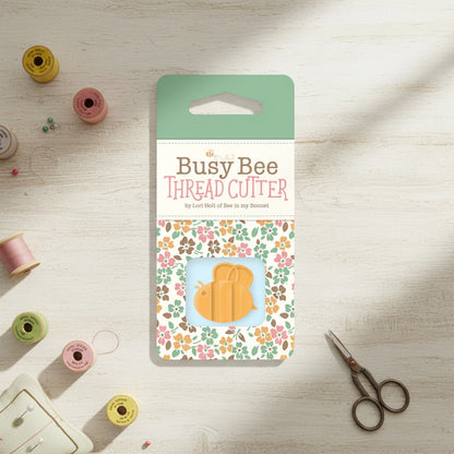 Patchwork with Busyfingers Lori Holt Bee Thread Cutter, orange bee-shaped tool with hidden blade for sewing.