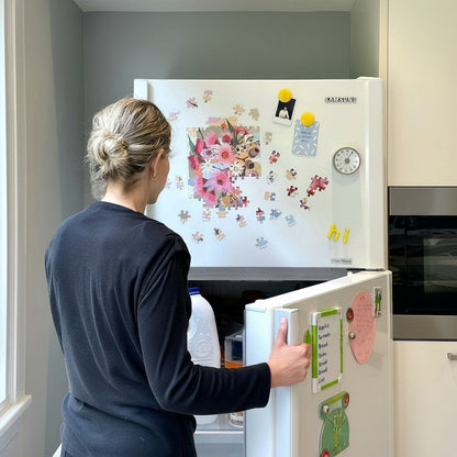 Patchwork with Busyfingers Magnetic Floral Art 100-piece puzzle on a fridge. Vibrant pink and yellow flowers with green leaves.