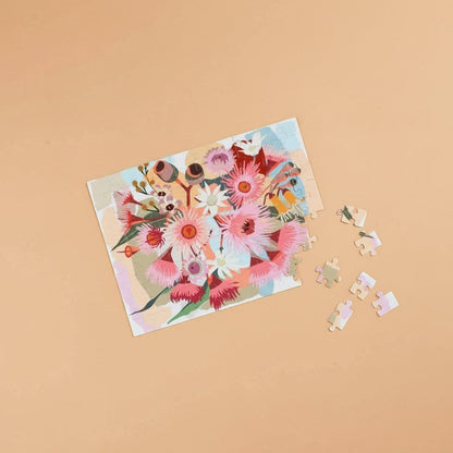 Patchwork with Busyfingers magnetic 100-piece floral art puzzle featuring pink and white native Australian flowers and gum nuts.