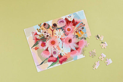 Patchwork with Busyfingers Magnetic Floral Art 100-piece puzzle featuring a vibrant bouquet of pink and white Australian native flowers and gum nuts.