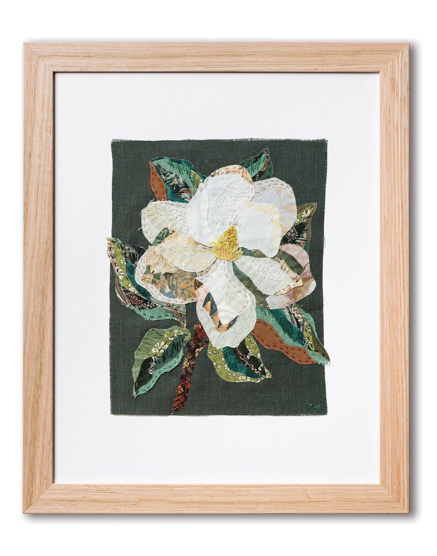 Patchwork with Busyfingers Magnolia slow-stitching fabric art featuring white petals and green leaves in a wood frame.