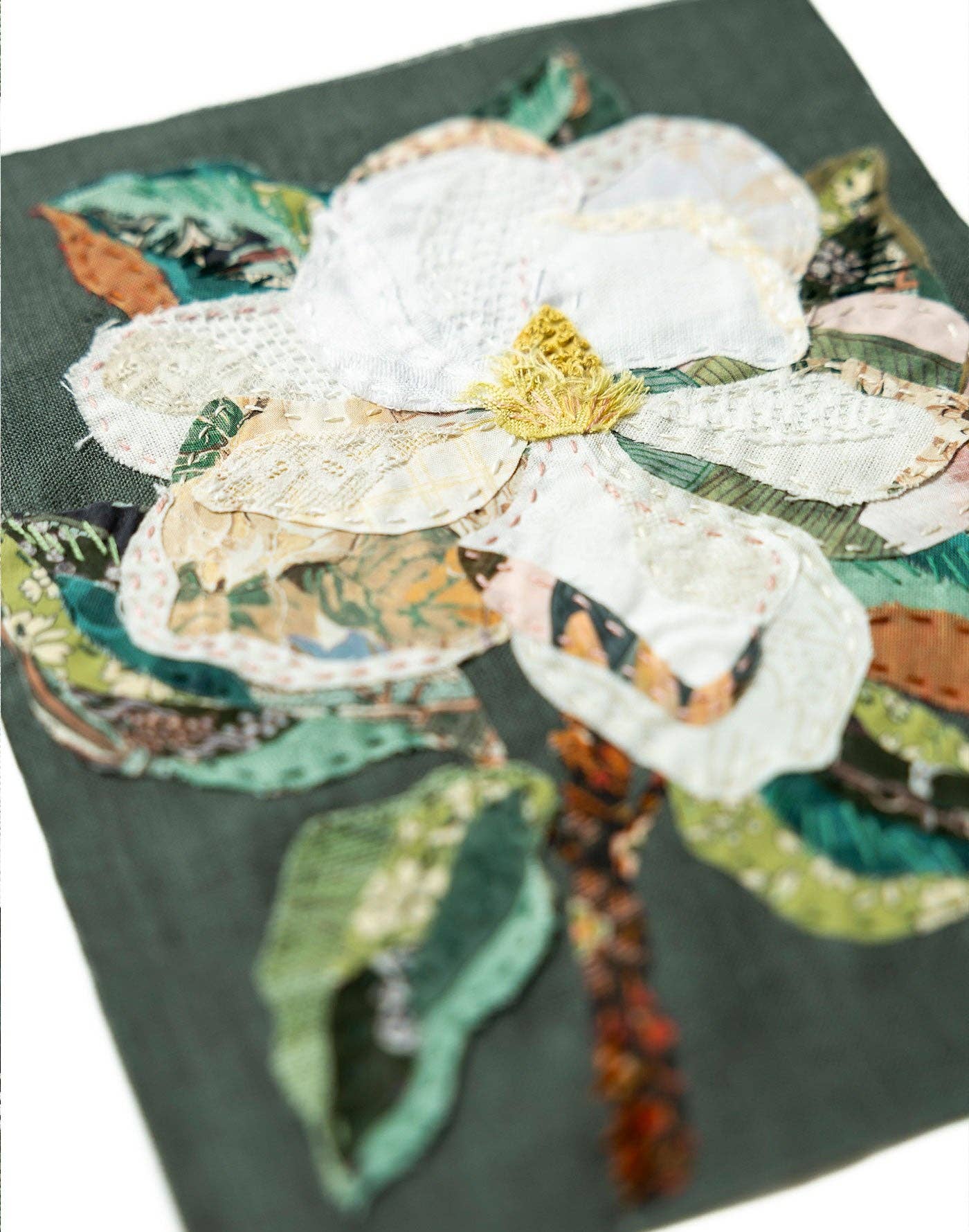Patchwork with Busyfingers Magnolia slow-stitching kit featuring layered white fabric petals and green leaves.
