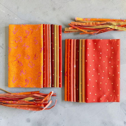 Patchwork with Busyfingers Marigold Spice cotton fabric fat eighth pack featuring 8 assorted orange and red prints.