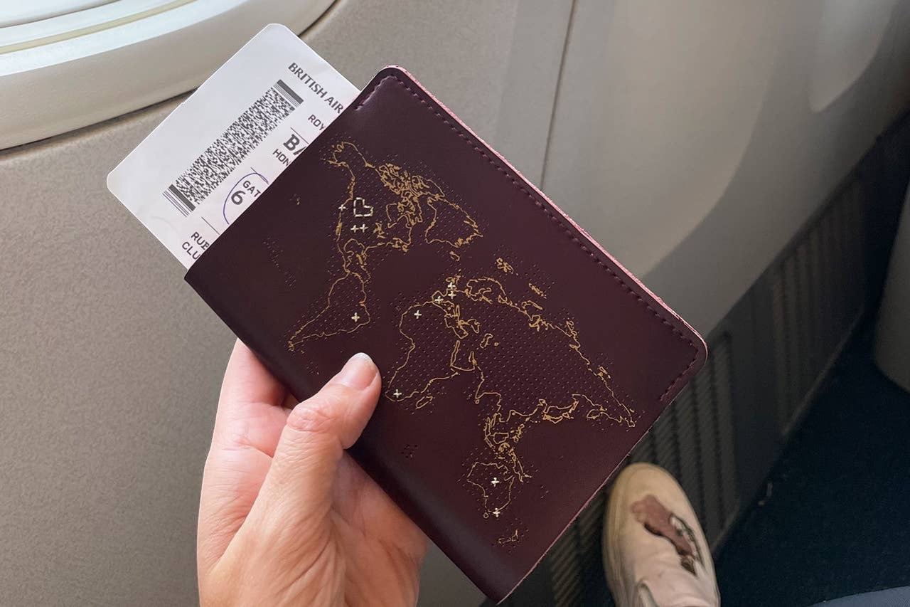 Patchwork with Busyfingers maroon leather passport cover with gold world map design and boarding pass.