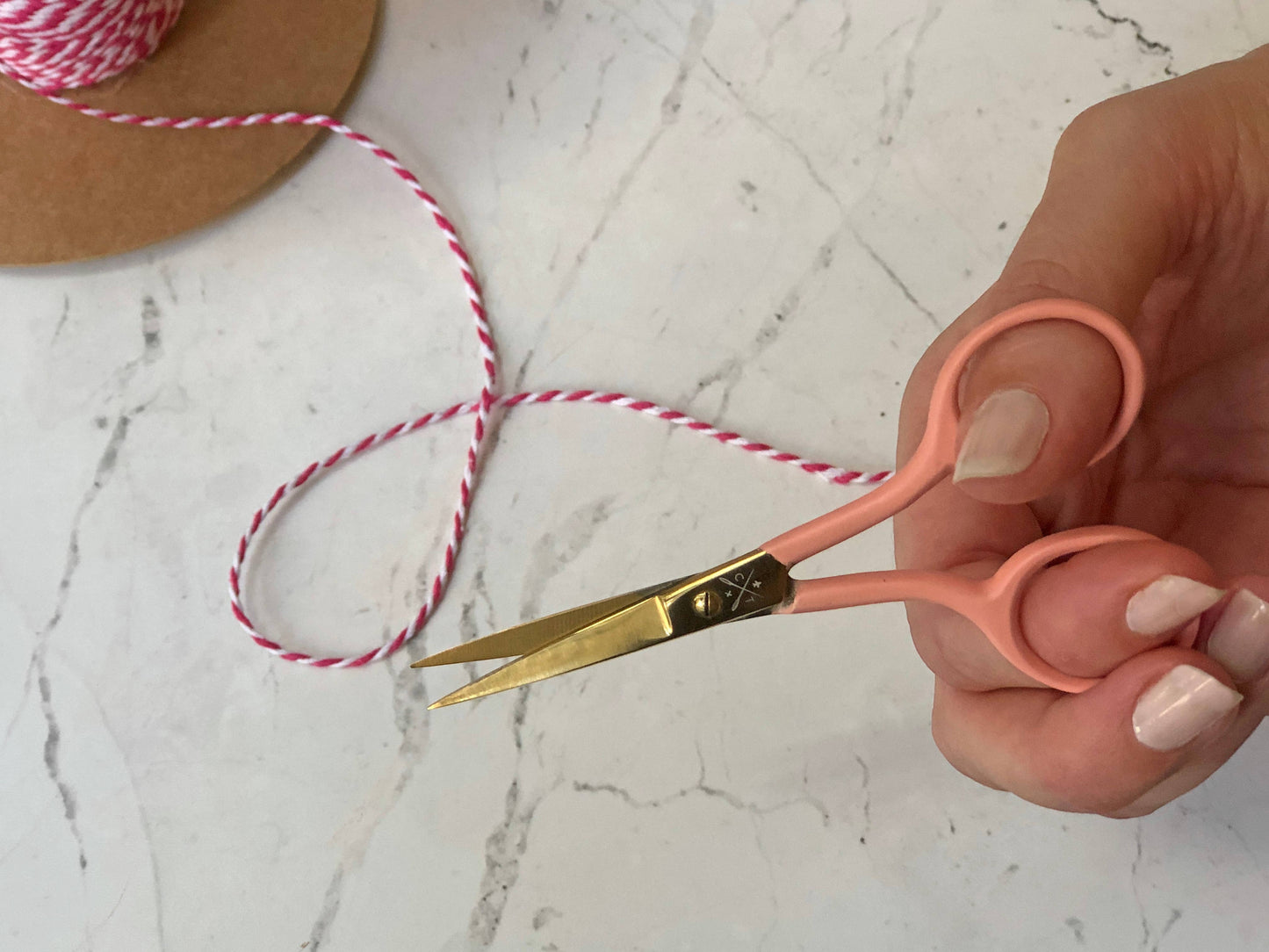 Patchwork with Busyfingers mint coloured embroidery scissors with gold blades and pink handles, perfect for cutting threads.