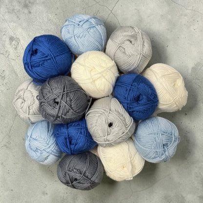 Patchwork with Busyfingers Mist & Minerals yarn set in white, duck egg blue, steel blue, and marled grey. 100% anti-pilling acrylic yarn.