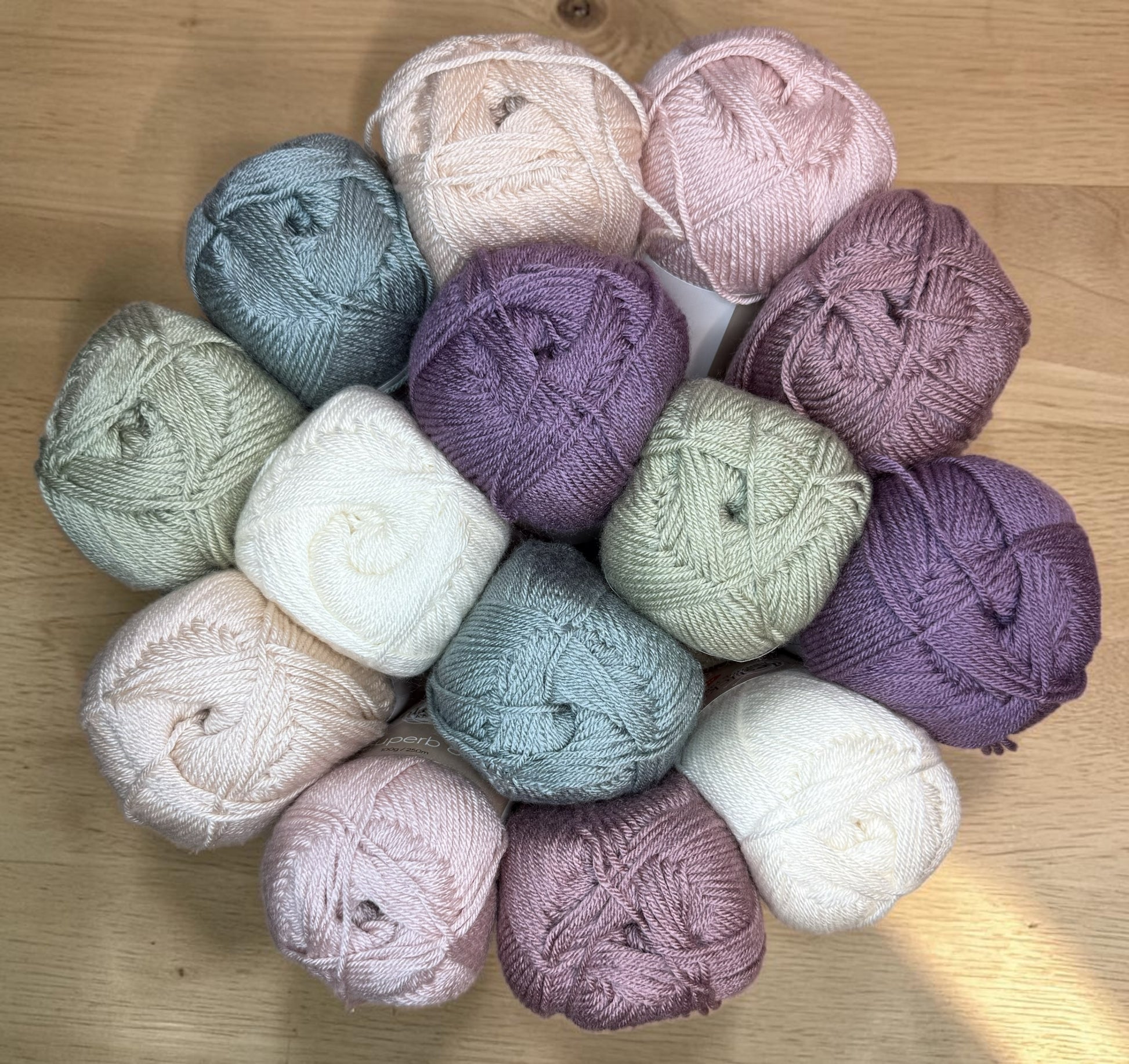 Patchwork with Busyfingers Mulberry Cottage Yarn Set in pastel shades of sage, cream, pink, purple, and moss. 100% anti-pilling acrylic yarn.