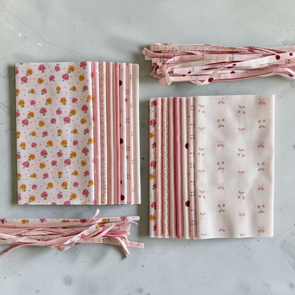 Patchwork with Busyfingers 8-piece cotton fat eighth fabric pack featuring assorted pink floral and patterned prints.