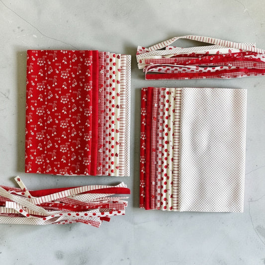Patchwork with Busyfingers Strawberries and Cream cotton fabric fat eighth pack with 8 assorted red and white prints.
